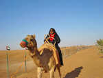 Jackie Sunshine Smith rides camel in Dubai desert.jpg